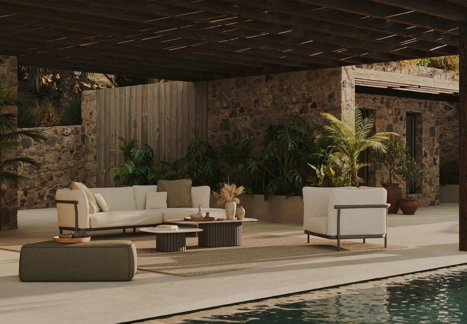 A Manutti Nami lounge in a shaded Mediterranean courtyard.